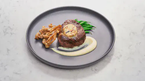 Beef Tenderloin with Crispy Enoki Mushrooms and Black Garlic-Miso Butter Image 